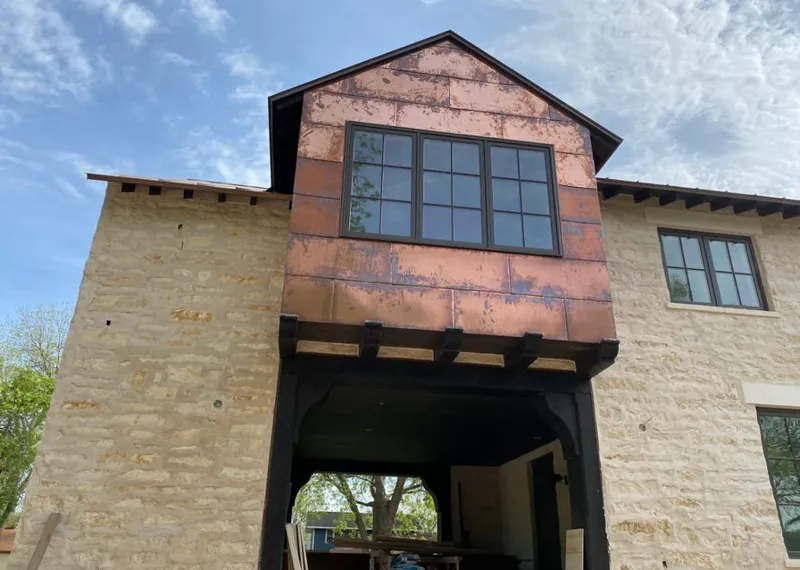 Copper metal panel facade on a stone building for Skylight Installation in Cotati