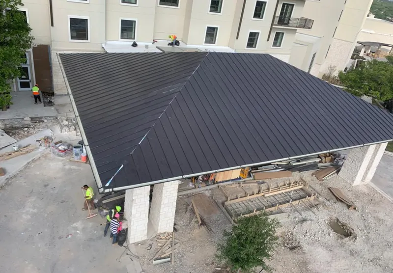 Metal roofing installation team working on a commercial building in Cotati